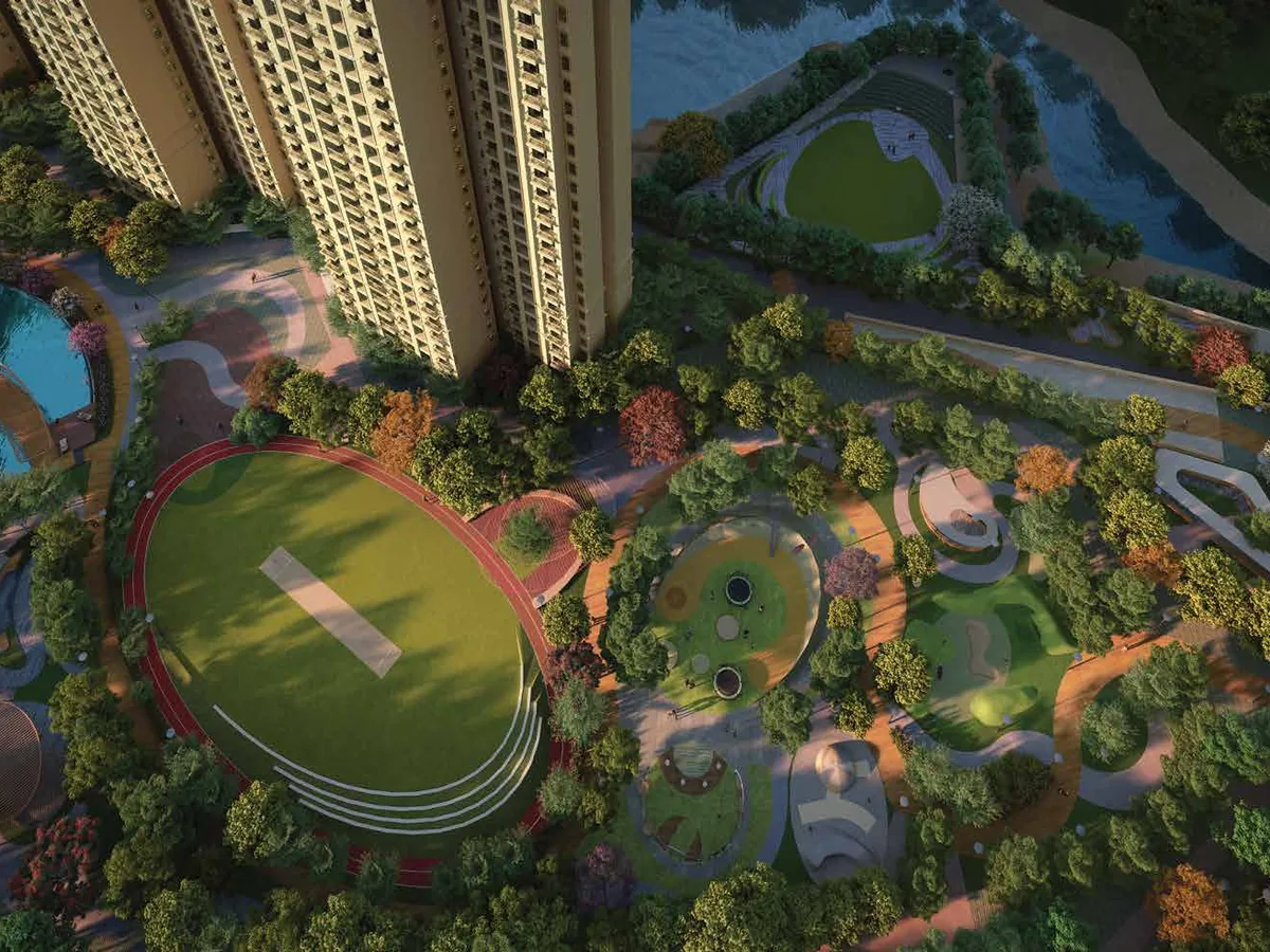 Aerial view of The Arena's landscaped amenity zone with cricket pitch, pool and playground